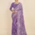 Front view of a model wearing a Purple Printed Georgette Saree with an elegant traditional border, showcasing the graceful drape and vibrant print for daily wear.