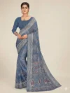 Front view of a model in a Navy Blue Printed Georgette Saree with a traditional woven border, featuring elegant floral prints. A perfect lightweight saree for office wear and professional gatherings.
