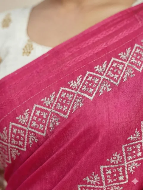 Detailed macro closeup of the bright pink printed georgette saree, highlighting the high-quality fabric texture and crisp silver-white traditional print details. Zoom in to appreciate the fine craftsmanship.